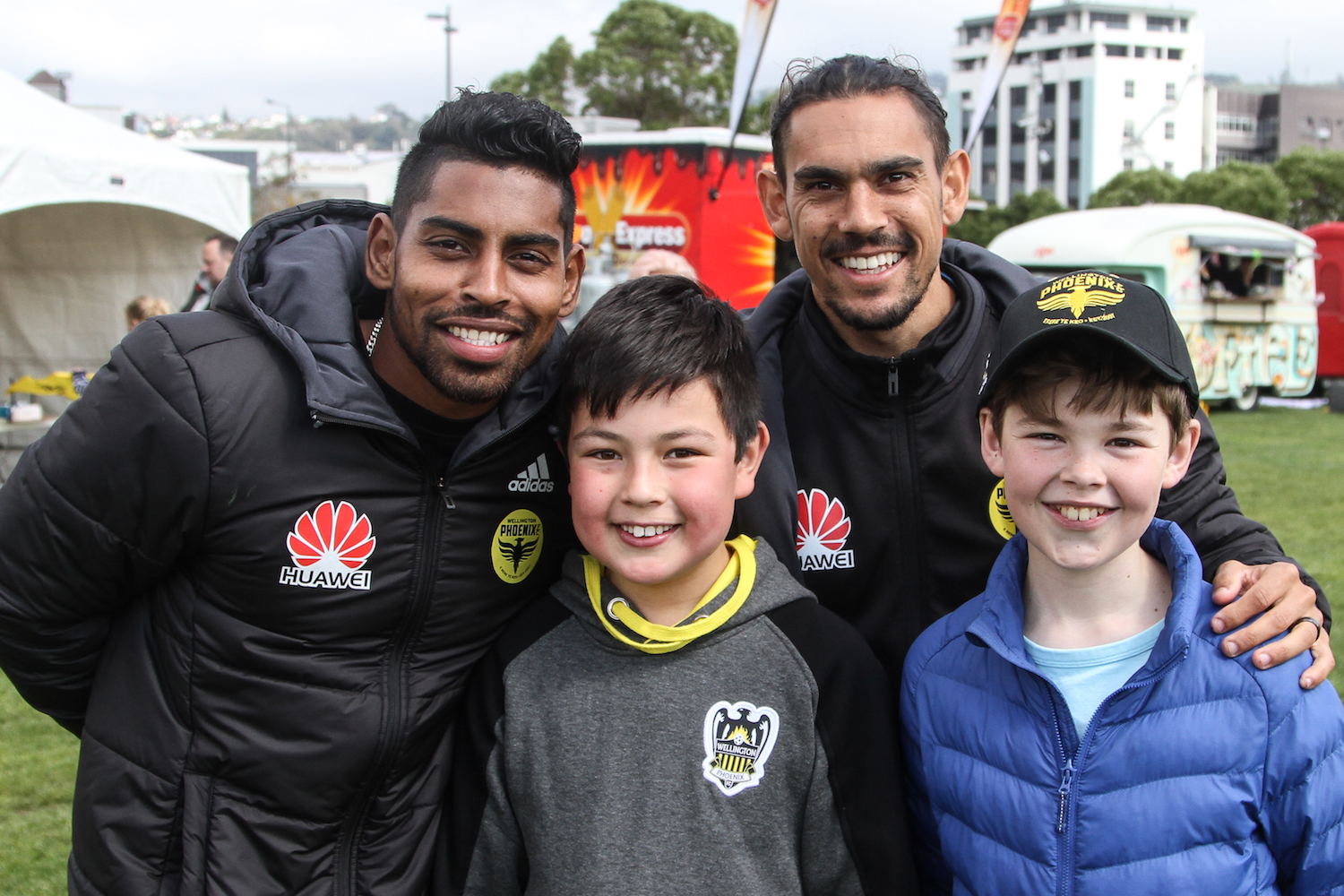 Roy Krishna and David Williams with young fans at Community Day